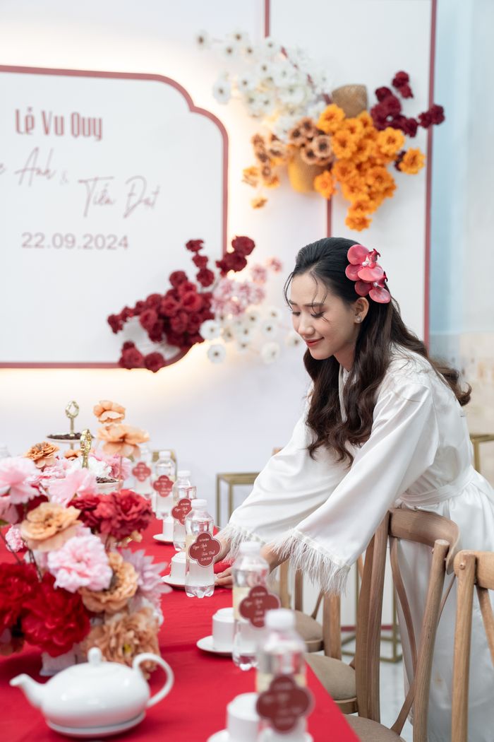 Woman arranging elegant floral and table settings at a wedding.